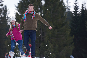 Image showing couple having fun and walking in snow shoes