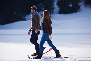 Image showing couple having fun and walking in snow shoes