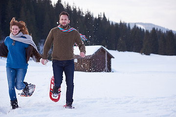 Image showing couple having fun and walking in snow shoes