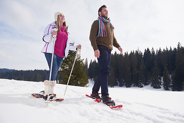 Image showing couple having fun and walking in snow shoes