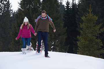 Image showing couple having fun and walking in snow shoes