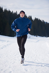 Image showing jogging on snow in forest