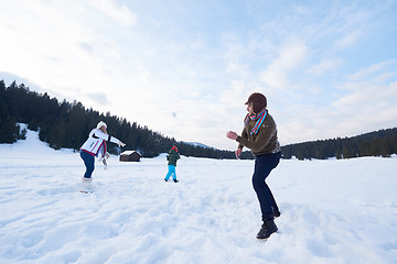 Image showing happy family playing together in snow at winter