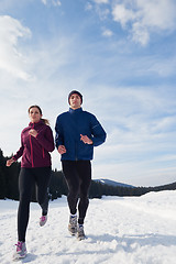 Image showing couple jogging outside on snow