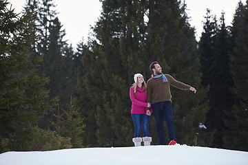 Image showing couple having fun and walking in snow shoes