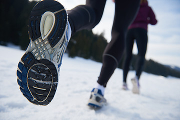 Image showing couple jogging outside on snow