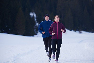 Image showing couple jogging outside on snow