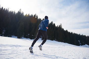 Image showing jogging on snow in forest