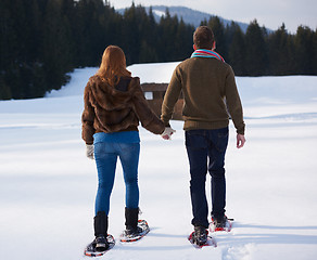 Image showing couple having fun and walking in snow shoes