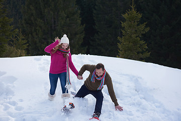 Image showing couple having fun and walking in snow shoes