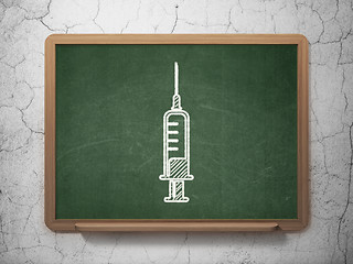 Image showing Healthcare concept: Syringe on chalkboard background