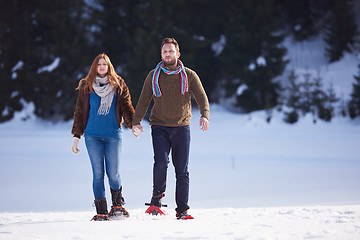 Image showing couple having fun and walking in snow shoes