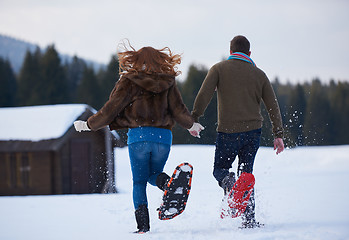 Image showing couple having fun and walking in snow shoes