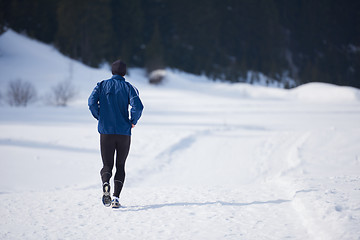 Image showing jogging on snow in forest