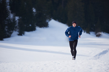 Image showing jogging on snow in forest