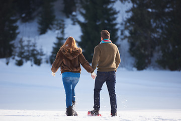 Image showing couple having fun and walking in snow shoes