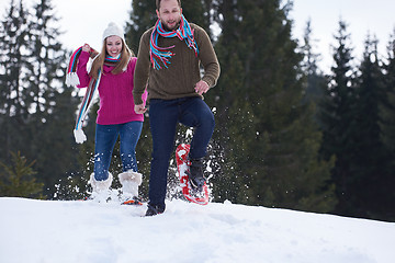 Image showing couple having fun and walking in snow shoes