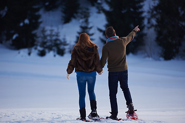 Image showing couple having fun and walking in snow shoes