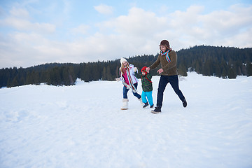 Image showing happy family playing together in snow at winter