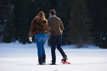 Image showing couple having fun and walking in snow shoes