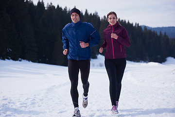 Image showing couple jogging outside on snow