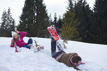 Image showing couple having fun and walking in snow shoes