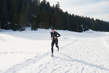 Image showing jogging on snow in forest