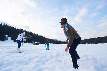 Image showing happy family playing together in snow at winter