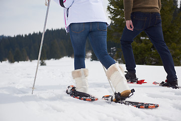 Image showing couple having fun and walking in snow shoes