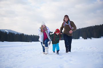 Image showing happy family playing together in snow at winter