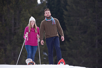 Image showing couple having fun and walking in snow shoes