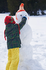 Image showing boy making snowman