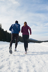 Image showing couple jogging outside on snow