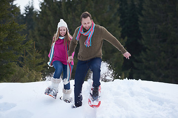 Image showing couple having fun and walking in snow shoes