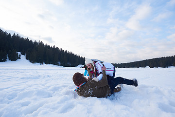 Image showing happy family playing together in snow at winter