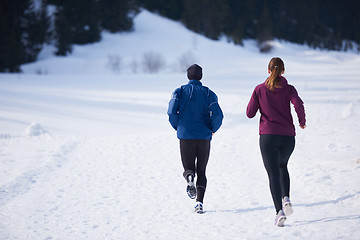 Image showing couple jogging outside on snow