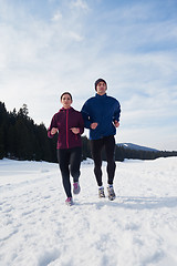 Image showing couple jogging outside on snow