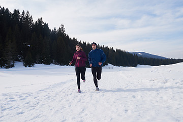 Image showing couple jogging outside on snow