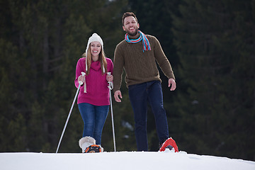 Image showing couple having fun and walking in snow shoes