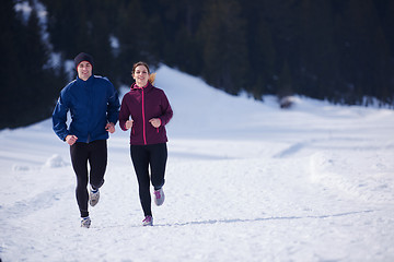 Image showing couple jogging outside on snow