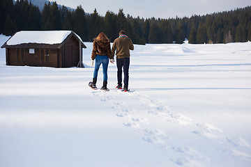 Image showing couple having fun and walking in snow shoes