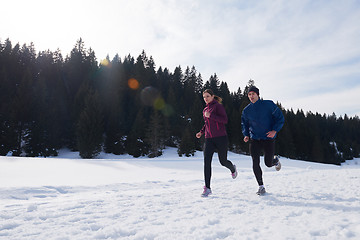 Image showing couple jogging outside on snow