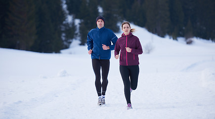 Image showing couple jogging outside on snow