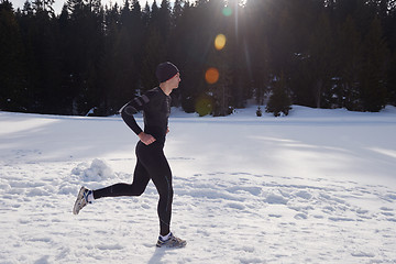 Image showing jogging on snow in forest