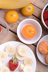 Image showing Fresh colorful fruits composition mandarin, strawberry, peach, bananas and orange
