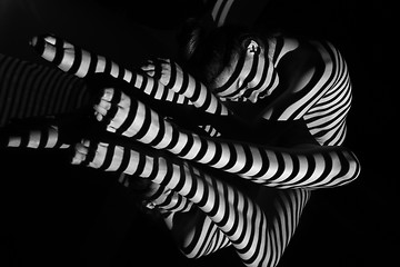 Image showing The nude woman with black and white zebra stripes