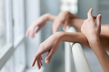 Image showing The  hands of two classic ballet dancers at barre