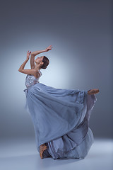 Image showing The beautiful ballerina dancing in blue long dress 