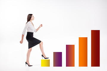 Image showing Young businesswoman walking up on stairs