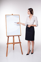 Image showing young business woman showing something on the white background